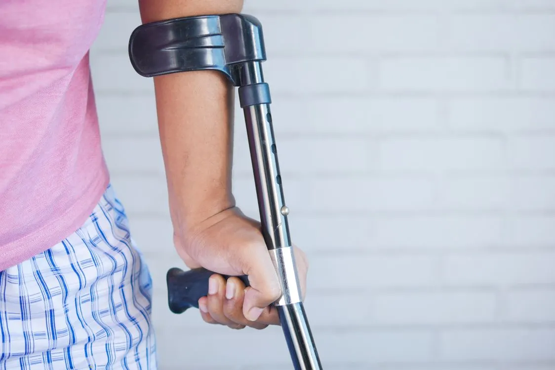 Person Holding Black and Silver Walking Stick